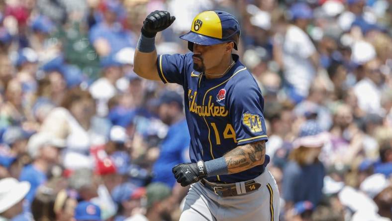 May 30, 2022; Chicago, Illinois, USA; Milwaukee Brewers third baseman Jace Peterson (14) rounds the bases after hitting a solo home run against the Chicago Cubs during the third inning of game one of a doubleheader at Wrigley Field. Mandatory Credit: Kamil Krzaczynski-USA TODAY Sports