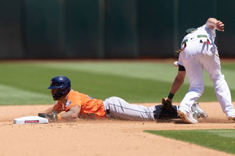 May 30, 2022; Oakland, California, USA; Houston Astros center fielder Jose Siri (26) slides into second base during the fifth inning against Oakland Athletics third baseman Sheldon Neuse (26) at RingCentral Coliseum. Mandatory Credit: Stan Szeto-USA TODAY Sports