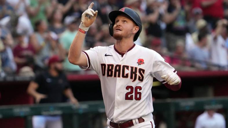 May 30, 2022; Phoenix, Arizona, USA; Arizona Diamondbacks first baseman Pavin Smith (26) gestures as he rounds the bases after hitting a three-run home run against the Atlanta Braves during the first inning at Chase Field. Mandatory Credit: Joe Camporeale-USA TODAY Sports