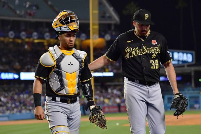 May 30, 2022; Los Angeles, California, USA; Pittsburgh Pirates relief pitcher Zach Thompson (39) meets with catcher Michael Perez (5) following the fifth inning against the Los Angeles Dodgers at Dodger Stadium. Mandatory Credit: Gary A. Vasquez-USA TODAY Sports