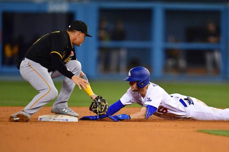 May 30, 2022; Los Angeles, California, USA; Los Angeles Dodgers shortstop Trea Turner (6) reaches second against Pittsburgh Pirates second baseman Diego Castillo (64) after hitting a double during the eighth inning at Dodger Stadium. Mandatory Credit: Gary A. Vasquez-USA TODAY Sports
