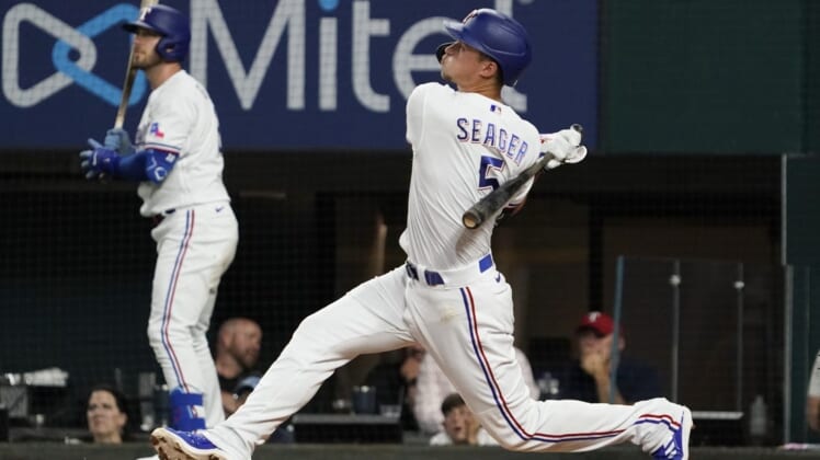 RMay 31, 2022; Arlington, Texas, USA; Texas Rangers shortstop Corey Seager (5) follows thru on a solo home run against the Tampa Bay Rays during the fourth inning at Globe Life Field. Mandatory Credit: Raymond Carlin III-USA TODAY Sports