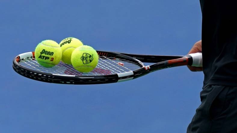 Aug 11, 2018; Mason, OH, USA; A view of the Penn tennis balls on the racket of Marcos Baghdatis (CYP) as he prepares to serve against Feliciano Lopez (ESP) in the Western and Southern tennis open at Lindner Family Tennis Center. Mandatory Credit: Aaron Doster-USA TODAY Sports