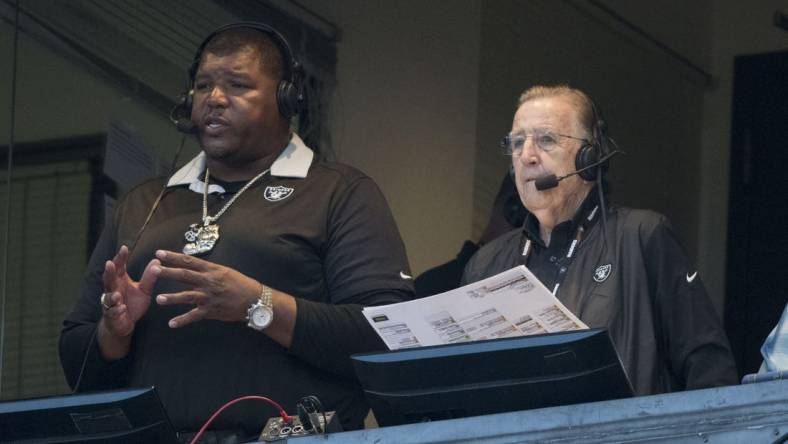 August 24, 2018; Oakland, CA, USA; Oakland Raiders broadcasters Lincoln Kennedy (left) and Brent Musburger (right) before the game against the Green Bay Packers at Oakland Coliseum. Mandatory Credit: Kyle Terada-USA TODAY Sports