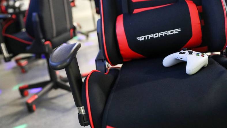 A gaming chair and controller are seen during an Evolve Youth Sports practice at the Player One arena in Carmel, Ind., Thursday, Jan. 24, 2019. Scott Wise, original founder of Scotty's Brewhouse, has partnered with Player One Esports for his next venture, a video game sports league that has attracted around 200 kids so far.

Evolve Youth Esports At Player One Arena In Carmel Ind Opened By Scott Wise Former Founder Of Scotty S Brewhouse Jan 24 2019