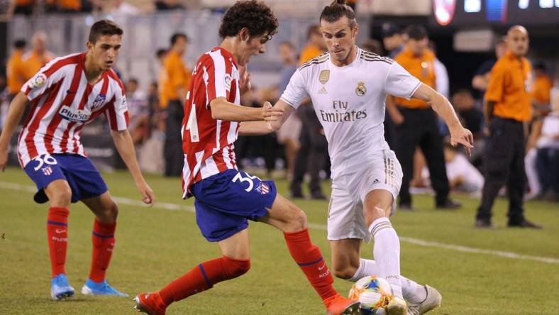 Jul 26, 2019; East Rutherford, NJ, USA; Real Madrid forward Gareth Bale (11) dribbles the ball as Atletico de Madrid forward Sergio Camello (34) defends during the second half of an International Champions Cup soccer series match at MetLife Stadium. Mandatory Credit: Brad Penner-USA TODAY Sports