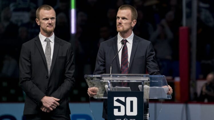 Feb 12, 2020; Vancouver, British Columbia, CAN;  Twin brothers Daniel Sedin (22) and Henrik Sedin (33) of Sweden speak while being honored in a ceremony held prior to a game between the Vancouver Canucks and Chicago Blackhawks. Mandatory Credit: Bob Frid-USA TODAY Sports