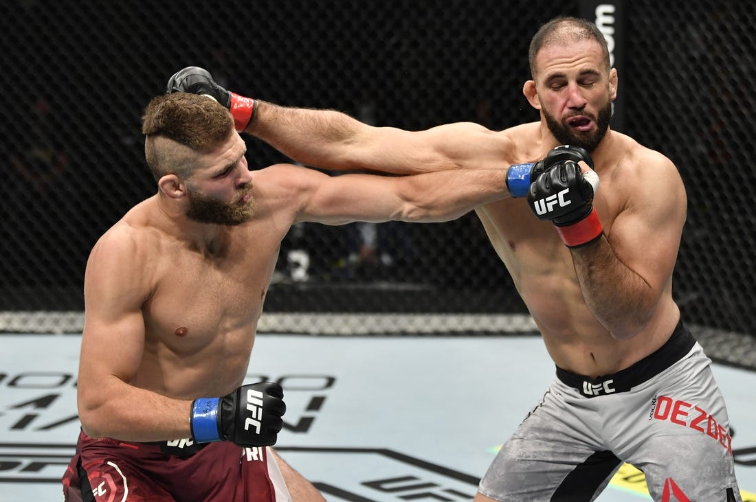 July 12, 2020; Abu Dhabi, UAE;  Jiri Prochazka of the Czech Republic punches Volkan Oezdemir of Switzerland in their light heavyweight fight during the UFC 251 event at Flash Forum on UFC Fight Island on July 12, 2020 on Yas Island, Abu Dhabi, United Arab Emirates. Mandatory Credit: Jeff Bottari/Zuffa LLC via USA TODAY Sports