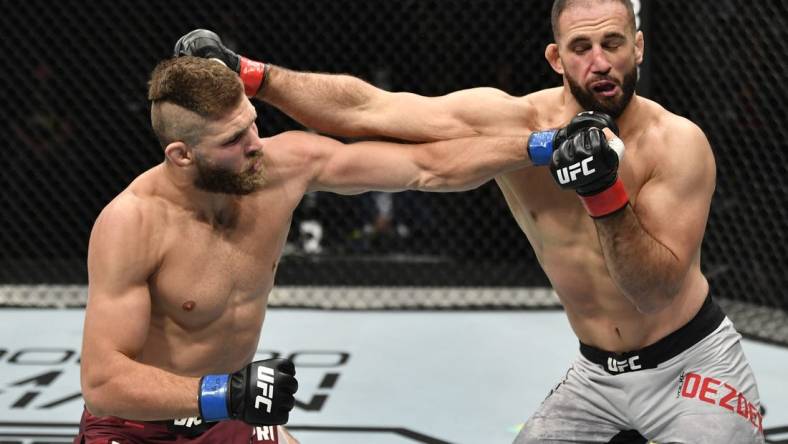 July 12, 2020; Abu Dhabi, UAE;  Jiri Prochazka of the Czech Republic punches Volkan Oezdemir of Switzerland in their light heavyweight fight during the UFC 251 event at Flash Forum on UFC Fight Island on July 12, 2020 on Yas Island, Abu Dhabi, United Arab Emirates. Mandatory Credit: Jeff Bottari/Zuffa LLC via USA TODAY Sports