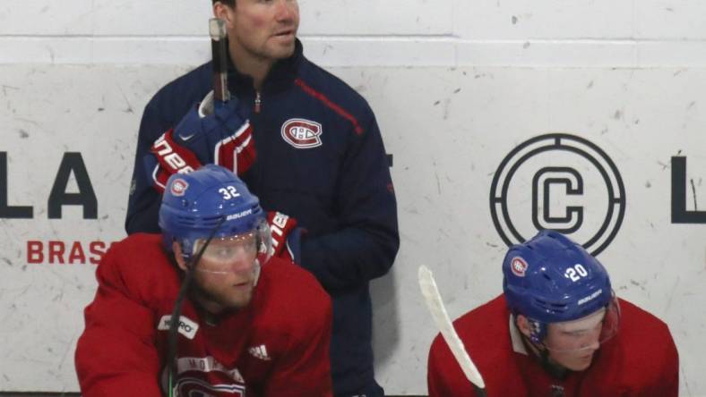 Jul 22, 2020; Montreal, Quebec, CANADA; Montreal Canadiens assistant coach Luke Richardson and defensemen Christian Folin (32) and Cale Fleury (20) watch the play during a NHL workout at Bell Sports Complex. Mandatory Credit: Jean-Yves Ahern-USA TODAY Sports