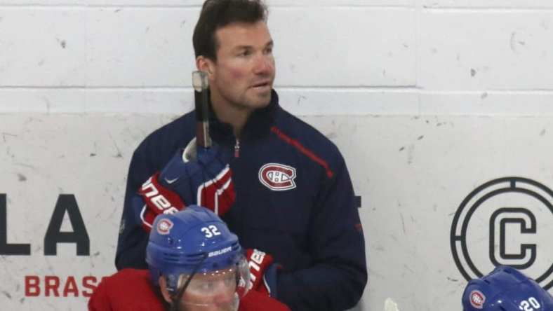 Jul 22, 2020; Montreal, Quebec, CANADA; Montreal Canadiens assistant coach Luke Richardson and defensemen Christian Folin (32) and Cale Fleury (20) watch the play during a NHL workout at Bell Sports Complex. Mandatory Credit: Jean-Yves Ahern-USA TODAY Sports