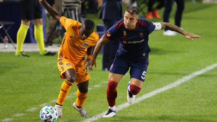 Sep 23, 2020; Chicago, Illinois, USA; Chicago Fire defender Francisco Calvo (5) knocks the ball away from Houston Dynamo forward Carlos Darwin Quintero (23) during the second half at Soldier Field. Mandatory Credit: Mike Dinovo-USA TODAY Sports