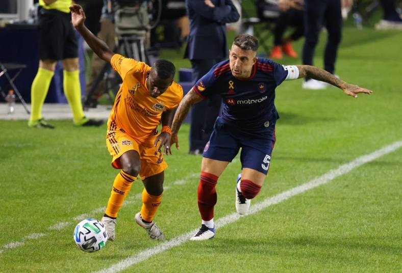 Sep 23, 2020; Chicago, Illinois, USA; Chicago Fire defender Francisco Calvo (5) knocks the ball away from Houston Dynamo forward Carlos Darwin Quintero (23) during the second half at Soldier Field. Mandatory Credit: Mike Dinovo-USA TODAY Sports