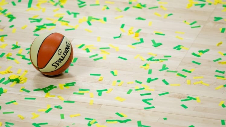 Oct 6, 2020; Bradenton, Florida, USA; A game ball rests on the court amidst green and yellow confetti after the Seattle Storm win the 2020 WNBA Finals at IMG Academy. Mandatory Credit: Mary Holt-USA TODAY Sports