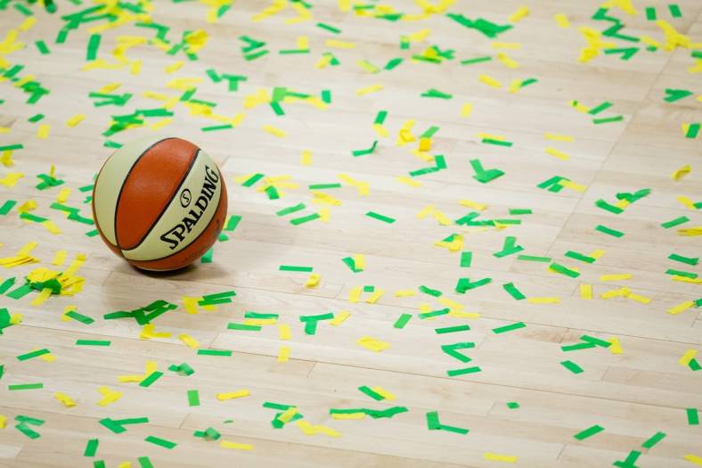 Oct 6, 2020; Bradenton, Florida, USA; A game ball rests on the court amidst green and yellow confetti after the Seattle Storm win the 2020 WNBA Finals at IMG Academy. Mandatory Credit: Mary Holt-USA TODAY Sports