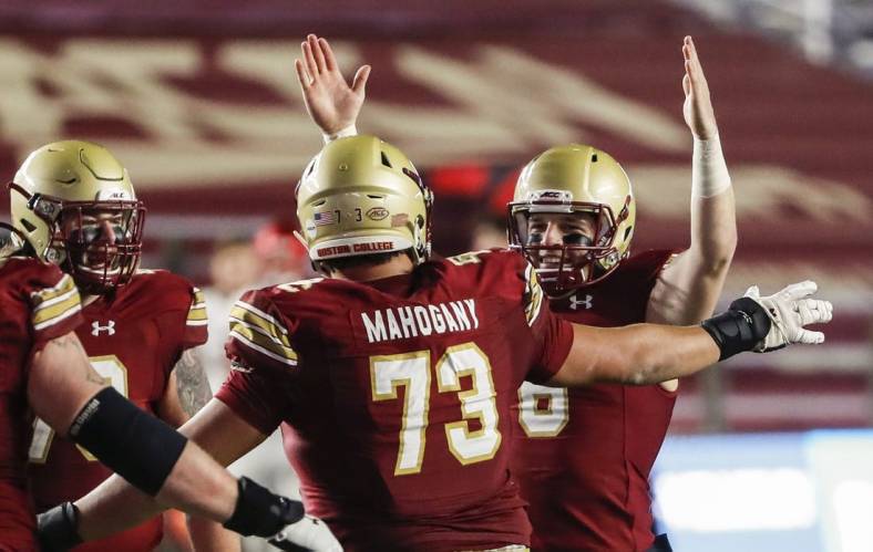 Nov 28, 2020; Chestnut Hill, Massachusetts, USA; Boston College Eagles quarterback Dennis Grosel (6) celebrates a touchdown pass with offensive lineman Christian Mahogany (73) against the Louisville Cardinals during the second half at Alumni Stadium. Mandatory Credit: Winslow Townson-USA TODAY Sports