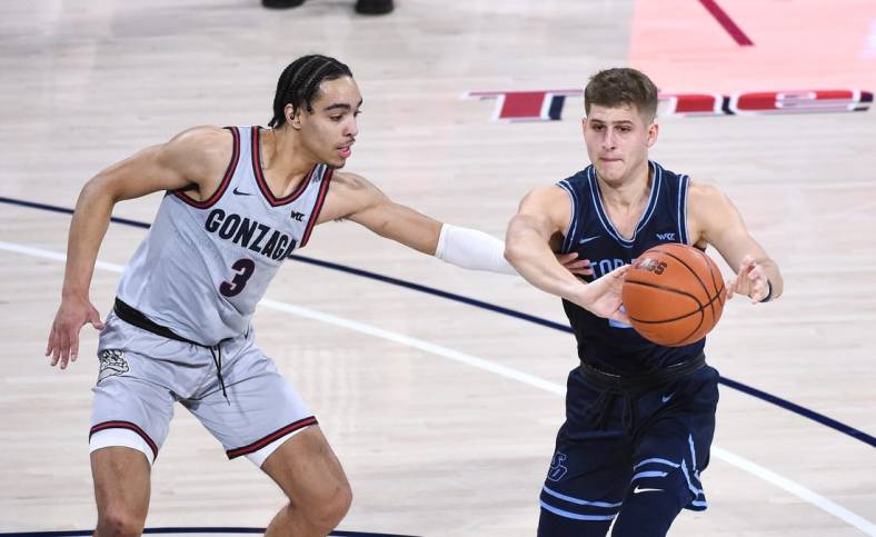 Feb 20, 2021; Spokane, Washington, USA; Gonzaga Bulldogs guard Andrew Nembhard (3) reaches for the ball against San Diego Toreros guard Joey Calcaterra (2) in the first half at McCarthey Athletic Center. Mandatory Credit: James Snook-USA TODAY Sports