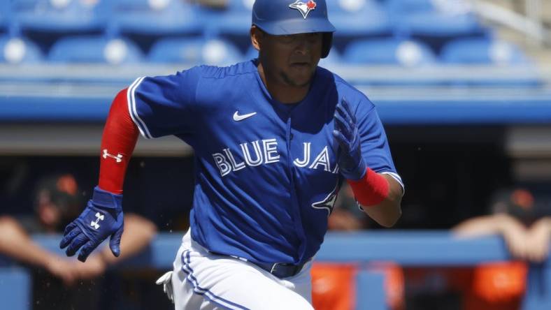 Mar 13, 2021; Dunedin, Florida, USA;  Toronto Blue Jays catcher Gabriel Moreno (70) runs to first base on a fielders choice during the second inning against the Baltimore Orioles at TD Ballpark. Mandatory Credit: Kim Klement-USA TODAY Sports