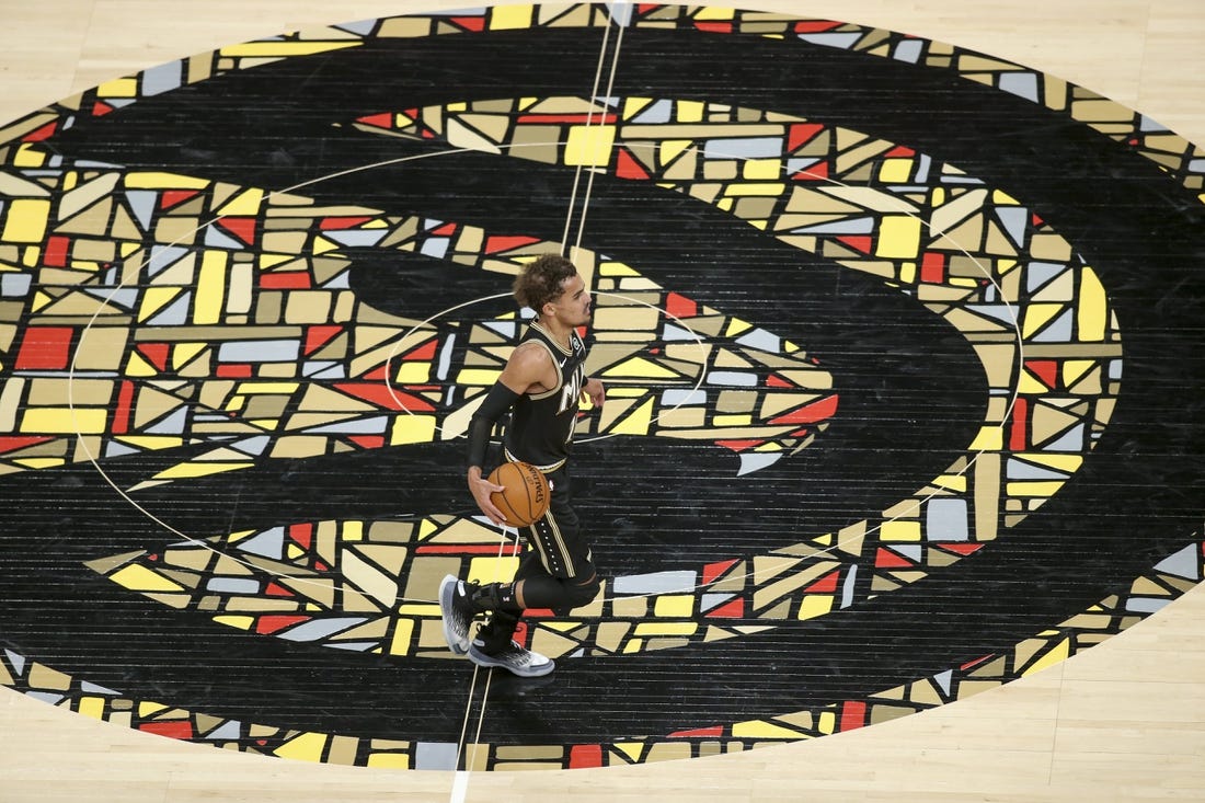 Apr 9, 2021; Atlanta, Georgia, USA; Atlanta Hawks guard Trae Young (11) dribbles across the logo against the Chicago Bulls in the second quarter at State Farm Arena. Mandatory Credit: Brett Davis-USA TODAY Sports