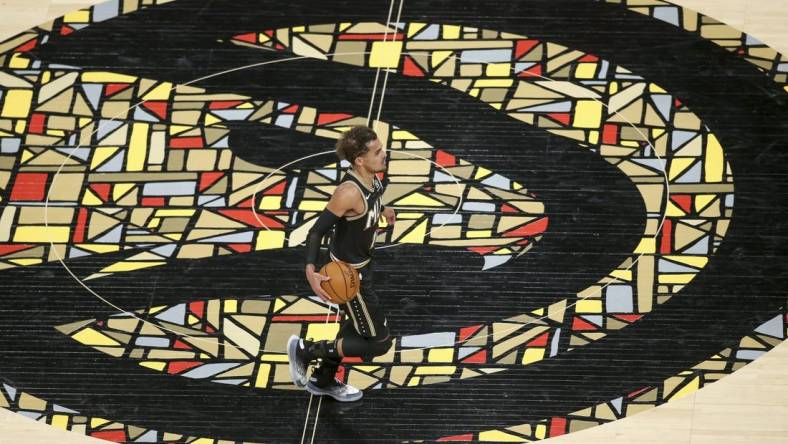 Apr 9, 2021; Atlanta, Georgia, USA; Atlanta Hawks guard Trae Young (11) dribbles across the logo against the Chicago Bulls in the second quarter at State Farm Arena. Mandatory Credit: Brett Davis-USA TODAY Sports