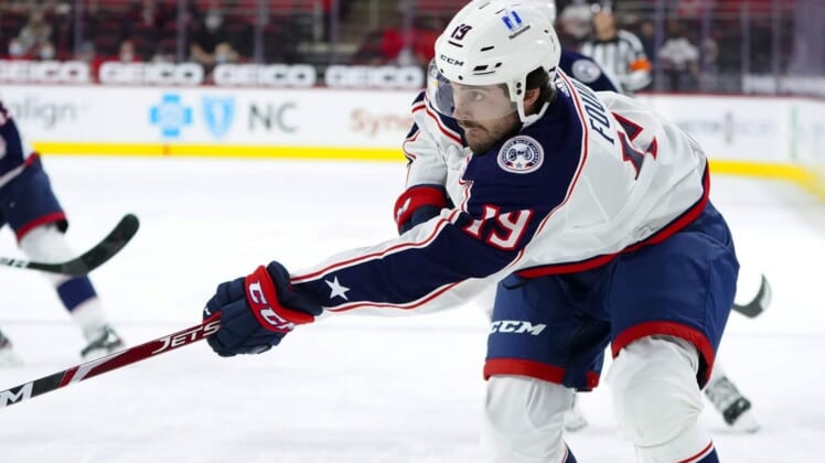 May 1, 2021; Raleigh, North Carolina, USA;  Columbus Blue Jackets center Liam Foudy (19) takes a first period shot against the Carolina Hurricanes at PNC Arena. Mandatory Credit: James Guillory-USA TODAY Sports