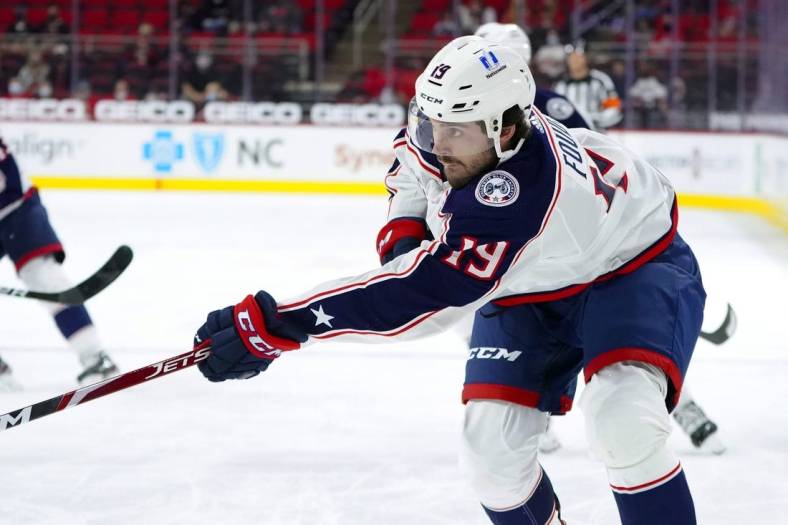 May 1, 2021; Raleigh, North Carolina, USA;  Columbus Blue Jackets center Liam Foudy (19) takes a first period shot against the Carolina Hurricanes at PNC Arena. Mandatory Credit: James Guillory-USA TODAY Sports