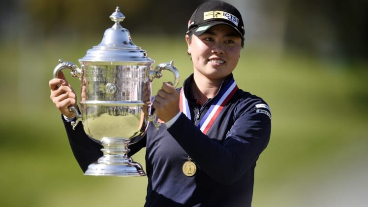 Jun 6, 2021; San Francisco, California, USA; Yuka Saso hoists the US Open trophy after winning in a sudden death playoff over Nasa Hataoka following the final round of the U.S. Women's Open golf tournament at The Olympic Club. Mandatory Credit: Kelvin Kuo-USA TODAY Sports