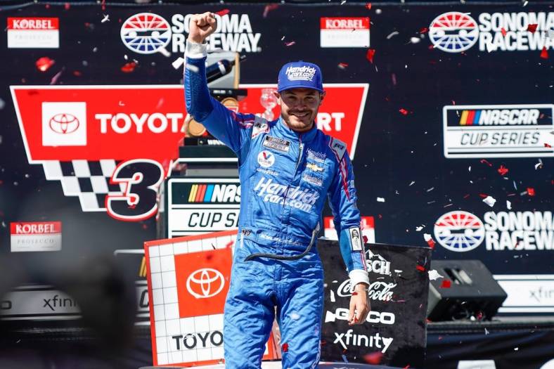 Jun 6, 2021; Sonoma, California, USA;  NASCAR Cup Series driver Kyle Larson (5) celebrates in confetti after winning the Toyota-Save Mart 350 at Sonoma Raceway. Mandatory Credit: Stan Szeto-USA TODAY Sports