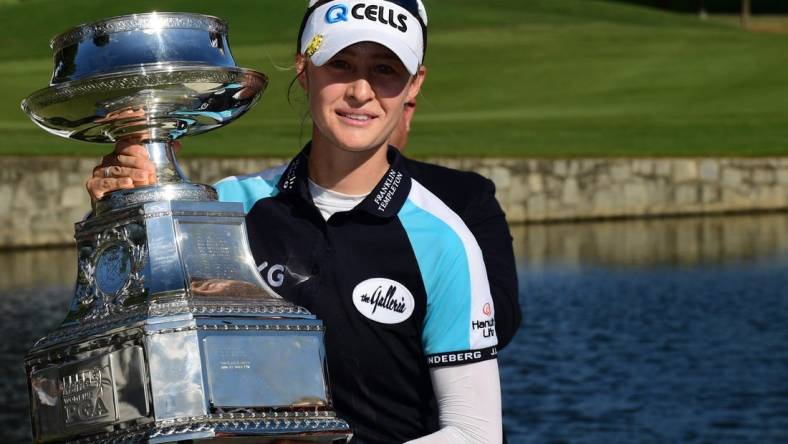 Jun 27, 2021; John's Creek, Georgia, USA; Nelly Korda holds the championship trophy as she celebrates winning the KPMG Women's PGA Championship golf tournament at the Atlanta Athletic Club. Mandatory Credit: Adam Hagy-USA TODAY Sports