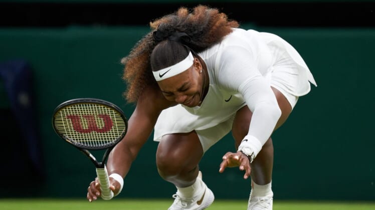 Jun 29, 2021; London, United Kingdom;  Serena Williams (USA) falls to the court while playing Aliaksandra Sasnovich (BLR) in first round ladies singles on centre court at All England Lawn Tennis and Croquet Club.  Mandatory Credit: Peter Van den Berg-USA TODAY Sports