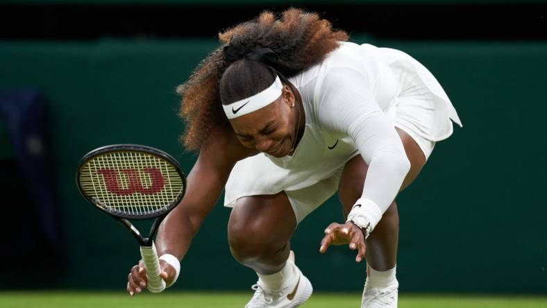 Jun 29, 2021; London, United Kingdom;  Serena Williams (USA) falls to the court while playing Aliaksandra Sasnovich (BLR) in first round ladies singles on centre court at All England Lawn Tennis and Croquet Club. 
 Mandatory Credit: Peter Van den Berg-USA TODAY Sports