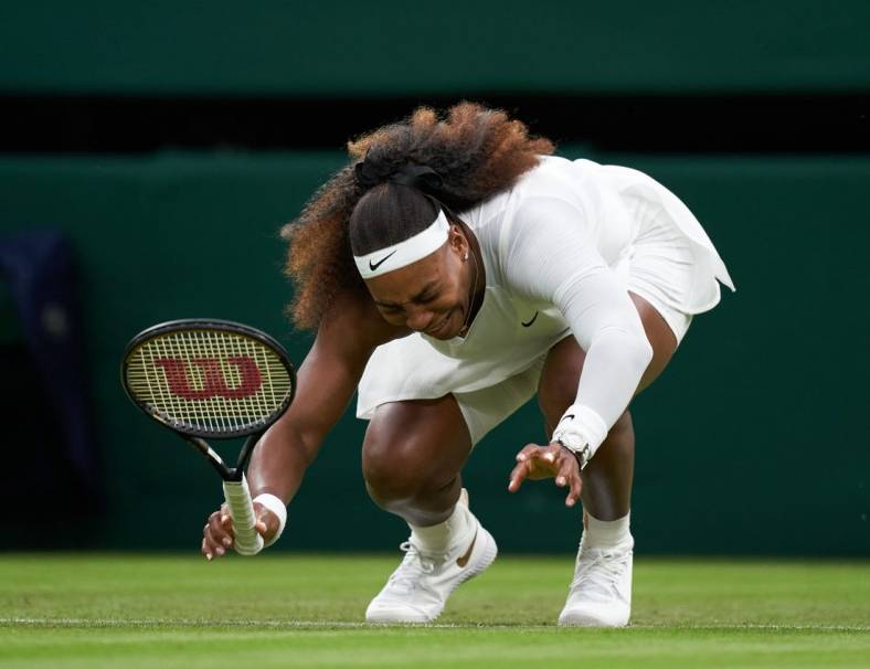Jun 29, 2021; London, United Kingdom;  Serena Williams (USA) falls to the court while playing Aliaksandra Sasnovich (BLR) in first round ladies singles on centre court at All England Lawn Tennis and Croquet Club. 
 Mandatory Credit: Peter Van den Berg-USA TODAY Sports