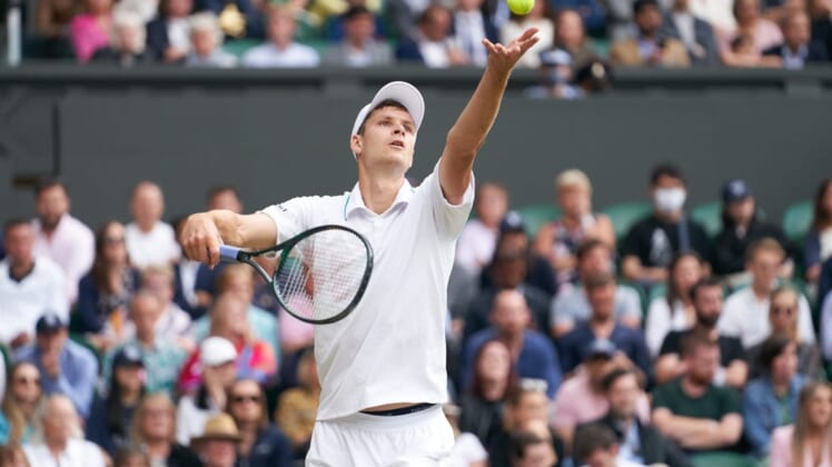 Jul 7, 2021; London, United Kingdom; Hubert Hurkacz (POL) seen in service action against Roger Federer (SUI) in the quarter finals at All England Lawn Tennis and Croquet Club. Mandatory Credit: Peter van den Berg-USA TODAY Sports