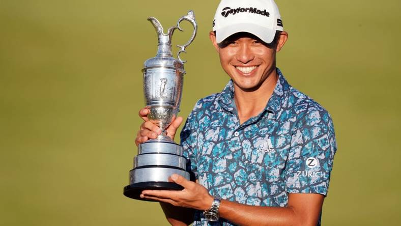 Jul 18, 2021; Sandwich, England, GBR; Collin Morikawa celebrates with the Claret Jug on the 18th green following his final round winning the Open Championship golf tournament. Mandatory Credit: Peter van den Berg-USA TODAY Sports