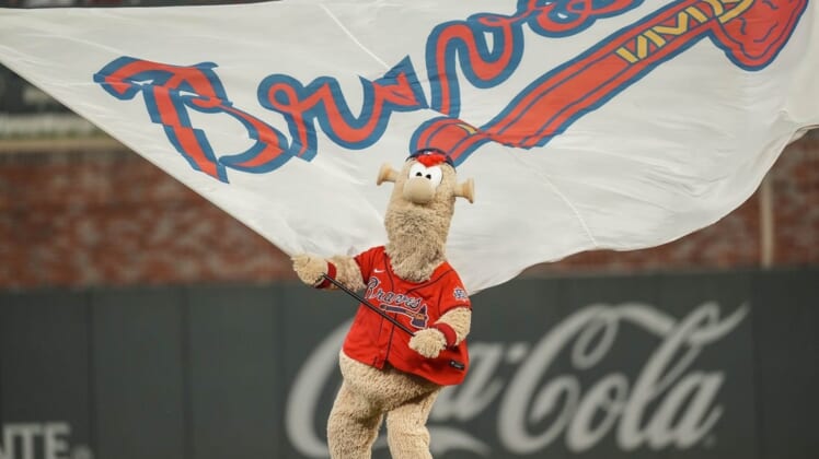 Aug 6, 2021; Cumberland, Georgia, USA; Atlanta Braves mascot Blooper waves the flag after the Braves defeated the Washington Nationals at Truist Park. Mandatory Credit: Dale Zanine-USA TODAY Sports