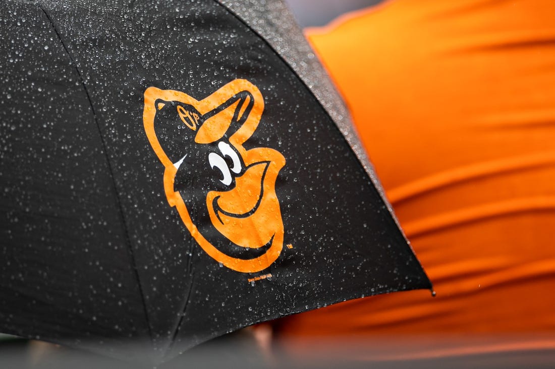 Aug 22, 2021; Baltimore, Maryland, USA; A Baltimore Orioles logo is seen on an umbrella during the game between the Baltimore Orioles and the Atlanta Braves at Oriole Park at Camden Yards. Mandatory Credit: Scott Taetsch-USA TODAY Sports