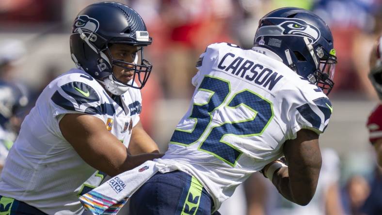 October 3, 2021; Santa Clara, California, USA; Seattle Seahawks quarterback Russell Wilson (3) hands the football off to running back Chris Carson (32) against the San Francisco 49ers during the first quarter at Levi's Stadium. Mandatory Credit: Kyle Terada-USA TODAY Sports