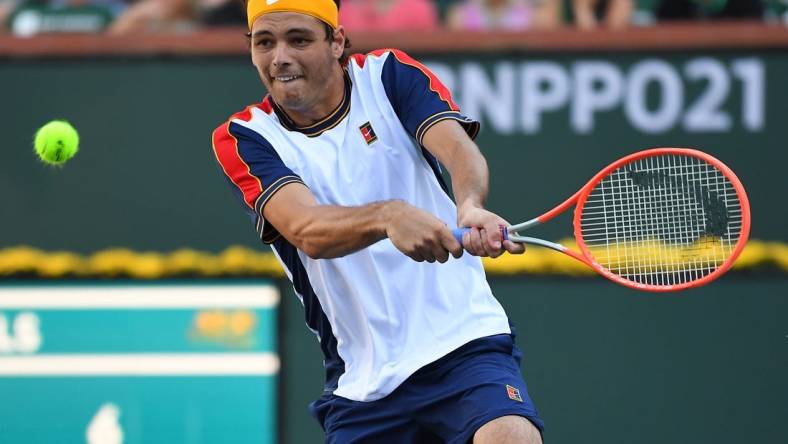 Oct 16, 2021; Indian Wells, CA, USA;  Taylor Fritz (USA) hits a shot in his semifinal match against Nikoloz Basilashvili (GEO) at the BNP Paribas Open at the Indian Wells Tennis Garden. Mandatory Credit: Jayne Kamin-Oncea-USA TODAY Sports