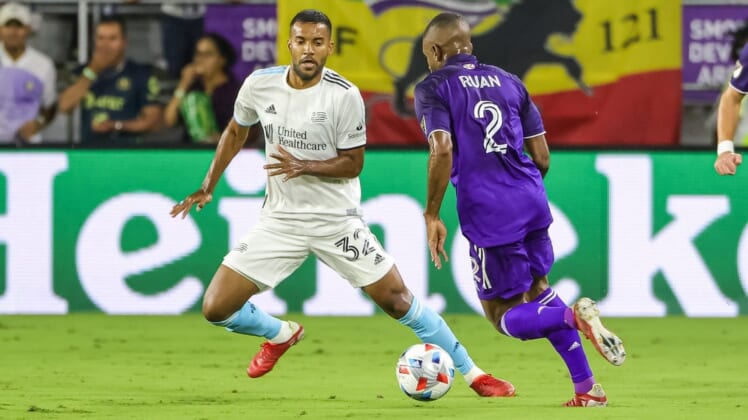 Oct 24, 2021; Orlando, Florida, USA; Orlando City defender Ruan (2) works the ball against New England Revolution defender Christian Mafla (32) during the first half at Orlando City Stadium. Mandatory Credit: Mike Watters-USA TODAY Sports