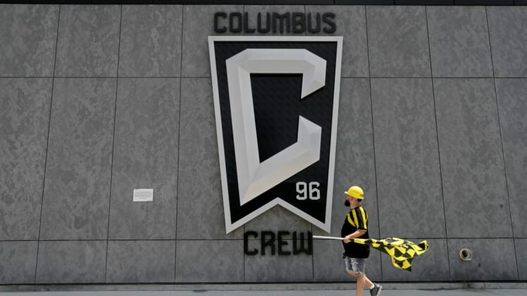 Nick Auddino, of Westerville, walks in front of a Columbus Crew logo on the west side of Lower.com Field before attending the inaugural match between the Columbus Crew and the New England Revolution in Columbus on Saturday, June 1, 2021. Auddino is a longtime Crew supporter who has only missed one game for the birth of his son. His children Jordan, 12, and Laina, 6, Auddino, were attending the match with him.Ceb Crew 0705 Bjp 01
