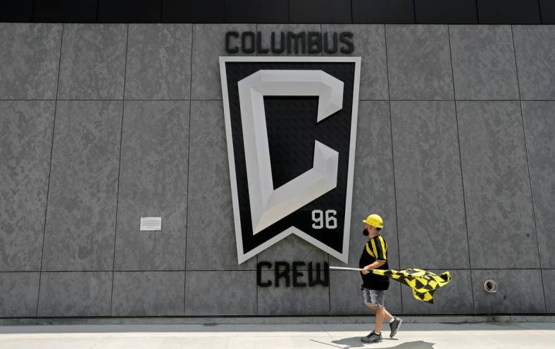 Nick Auddino, of Westerville, walks in front of a Columbus Crew logo on the west side of Lower.com Field before attending the inaugural match between the Columbus Crew and the New England Revolution in Columbus on Saturday, June 1, 2021. Auddino is a longtime Crew supporter who has only missed one game for the birth of his son. His children Jordan, 12, and Laina, 6, Auddino, were attending the match with him.

Ceb Crew 0705 Bjp 01