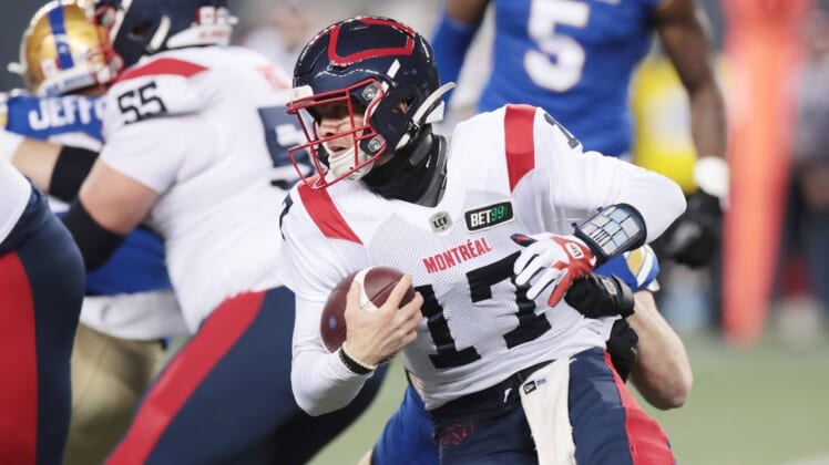Nov 6, 2021; Winnipeg, Manitoba, CAN; Montreal Alouettes quarterback Trevor Harris (17) is tackled from behind during a Canadian football League game at IG Field. Mandatory Credit: Bruce Fedyck-USA TODAY Sports
