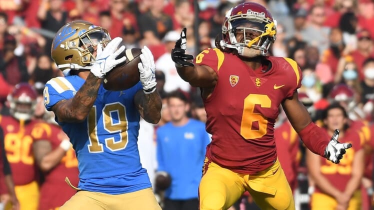 Nov 20, 2021; Los Angeles, California, USA;  UCLA Bruins running back Kazmeir Allen (19) catches a touchdown pass against Southern California Trojans cornerback Isaac Taylor-Stuart (6) in the first half at the Los Angeles Memorial Coliseum. Mandatory Credit: Richard Mackson-USA TODAY Sports