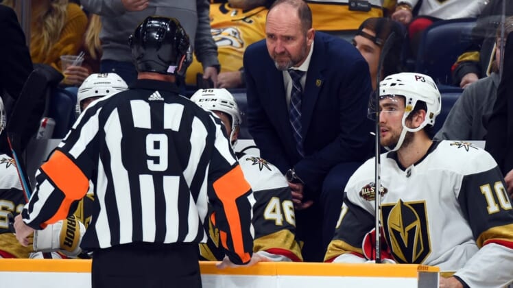 Nov 24, 2021; Nashville, Tennessee, USA; Vegas Golden Knights head coach Peter DeBoer challenges a goal call by referee Dan O'Rourke (9) during the second period against the Nashville Predators at Bridgestone Arena. Mandatory Credit: Christopher Hanewinckel-USA TODAY Sports