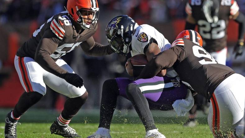 Ravens quarterback Lamar Jackson is brought down by Browns defensive end Myles Garrett (right) during the first half Sunday, Dec. 12, 2021, in Cleveland.

Browns 14