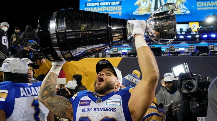 Dec 12, 2021; Hamilton, Ontario, CAN; Winnipeg Blue Bombers running back Brady Oliveira (20) celebrates with the Grey Cup after a win over the Hamilton Tiger-Cats in the 108th Grey Cup football game at Tim Hortons Field. Mandatory Credit: John E. Sokolowski-USA TODAY Sports
