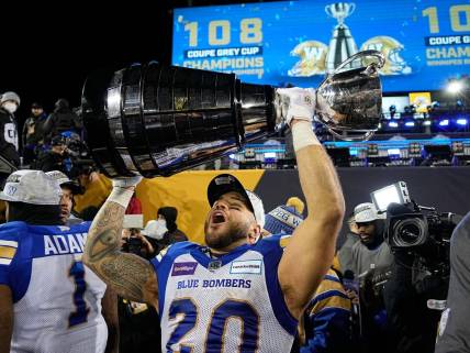 Dec 12, 2021; Hamilton, Ontario, CAN; Winnipeg Blue Bombers running back Brady Oliveira (20) celebrates with the Grey Cup after a win over the Hamilton Tiger-Cats in the 108th Grey Cup football game at Tim Hortons Field. Mandatory Credit: John E. Sokolowski-USA TODAY Sports