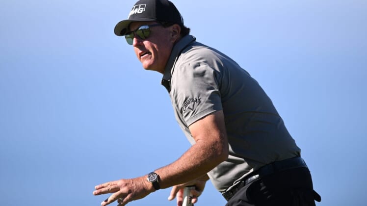 Jan 27, 2022; San Diego, California, USA; Phil Mickelson acknowledges the crowd after a putt on the fourth green during the first round of the Farmers Insurance Open golf tournament at Torrey Pines Municipal Golf Course - South Course. Mandatory Credit: Orlando Ramirez-USA TODAY Sports