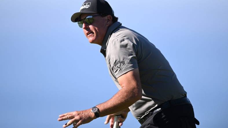 Jan 27, 2022; San Diego, California, USA; Phil Mickelson acknowledges the crowd after a putt on the fourth green during the first round of the Farmers Insurance Open golf tournament at Torrey Pines Municipal Golf Course - South Course. Mandatory Credit: Orlando Ramirez-USA TODAY Sports