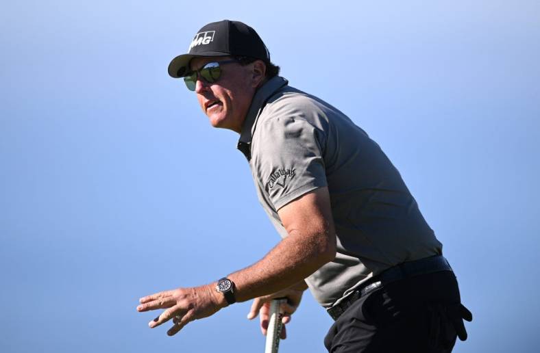 Jan 27, 2022; San Diego, California, USA; Phil Mickelson acknowledges the crowd after a putt on the fourth green during the first round of the Farmers Insurance Open golf tournament at Torrey Pines Municipal Golf Course - South Course. Mandatory Credit: Orlando Ramirez-USA TODAY Sports